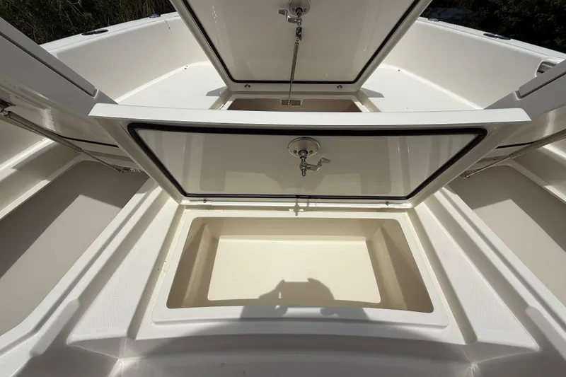 Slide: The Image of 2026 Pathfinder 2400 TRS boat storage compartments open, showcasing spacious interior design. - 38