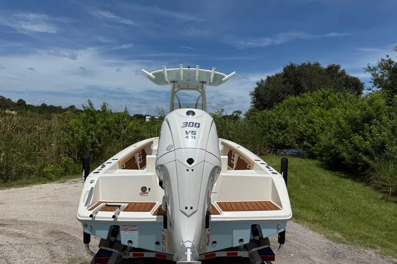 Slide: The Image of 2026 Pathfinder 2400 TRS boat with powerful 300 V6 engine, parked outdoors. - 4