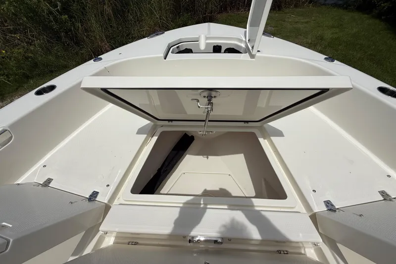 Slide: The Image of 2026 Pathfinder 2400 TRS boat with open storage compartment, showcasing spacious interior design. - 40