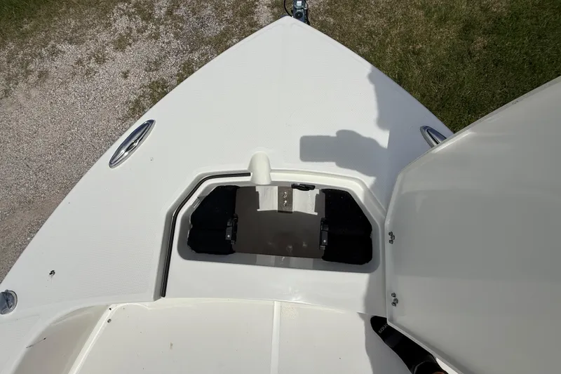 Slide: The Image of 2026 Pathfinder 2400 TRS boat deck with open storage compartment, viewed from above. - 41