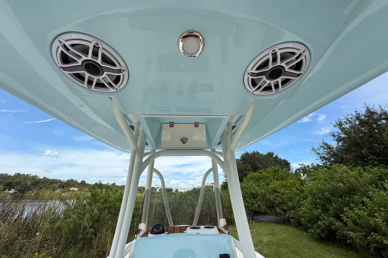 Slide: The Image of 2026 Pathfinder 2400 TRS boat with speakers and canopy, set against a lush landscape. - 42