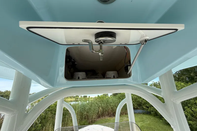 Slide: The Image of 2026 Pathfinder 2400 TRS boat storage compartment with open hatch, showcasing interior details. - 43