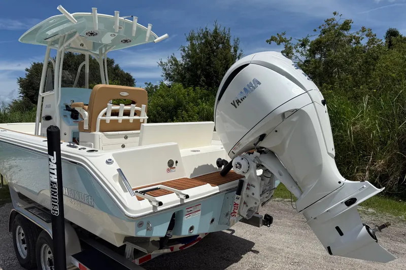 Slide: The Image of 2026 Pathfinder 2400 TRS boat with Yamaha outboard motor on trailer, parked outdoors. - 6