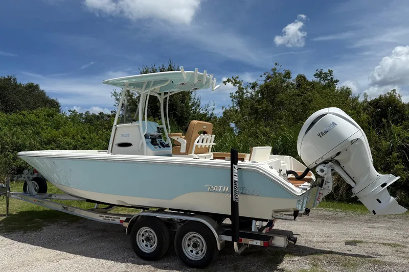 Slide: The Image of 2026 Pathfinder 2400 TRS boat on trailer with Yamaha outboard, parked outdoors. - 7