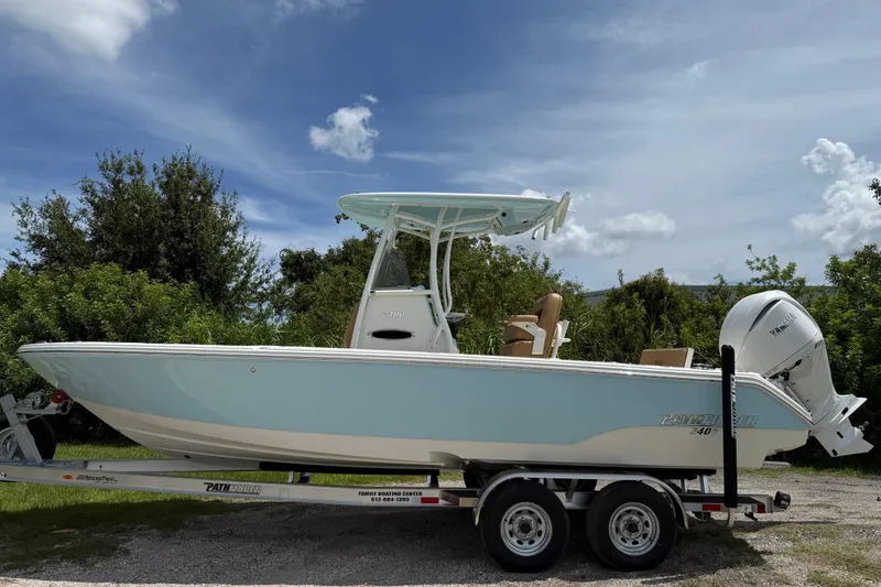 Slide: The Image of 2026 Pathfinder 2400 TRS boat on trailer, parked outdoors under a clear sky. - 8