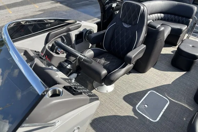 Slide: The Image of 2024 Bennington 25 QFBWA boat interior with luxurious seating and modern helm controls. - 10