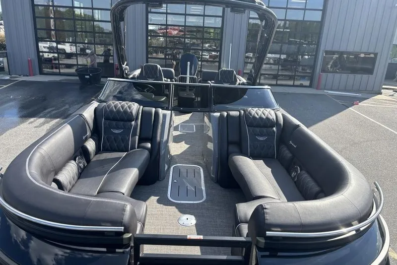 Slide: The Image of 2024 Bennington 25 QFBWA pontoon boat with luxurious seating and sleek design. - 11