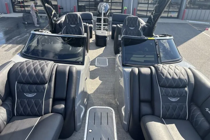 Slide: The Image of 2024 Bennington 25 QFBWA boat interior with luxurious black seating and sleek design. - 15