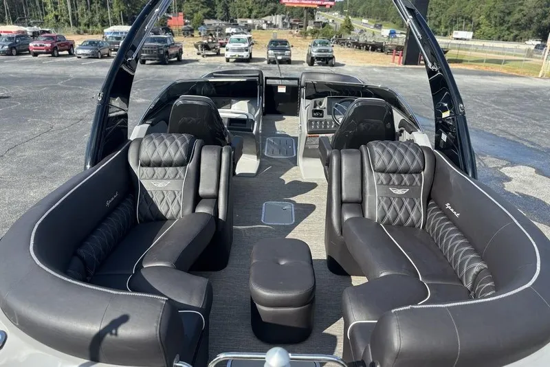 Slide: The Image of 2024 Bennington 25 QFBWA luxury boat interior with plush seating and modern dashboard. - 17