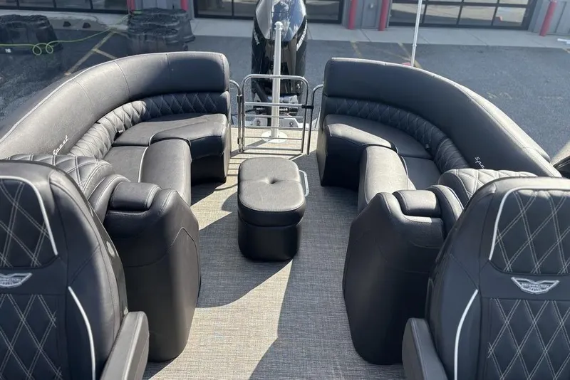 Slide: The Image of 2024 Bennington 25 QFBWA boat interior with luxurious black seating and modern design. - 18