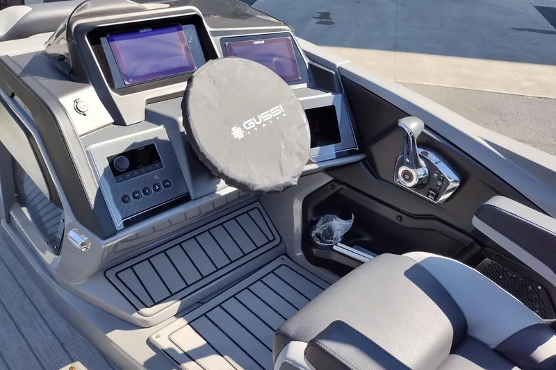 Slide: The Image of 2026 Tahoe Pontoon Grand Tahoe LTD Cruise dashboard with modern controls and steering. - 16