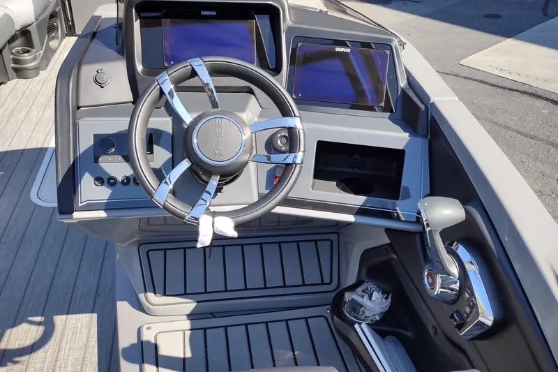 Slide: The Image of 2026 Tahoe Pontoon Grand Tahoe LTD Cruise dashboard with steering wheel and controls. - 29