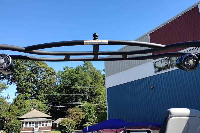 Slide: The Image of 2026 Tahoe Pontoon Grand Tahoe LTD Cruise Rear Bench with speakers, against blue sky backdrop. - 38