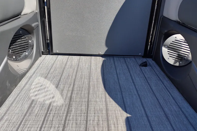 Slide: The Image of Interior of 2026 Tahoe Pontoon Grand Tahoe LTD Cruise Rear Bench with speakers and textured flooring. - 39