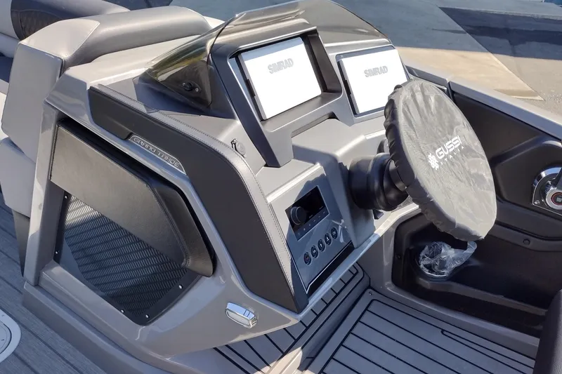 Slide: The Image of 2026 Tahoe Pontoon Grand Tahoe LTD Cruise dashboard with dual Simrad displays and Gussi steering wheel. - 42