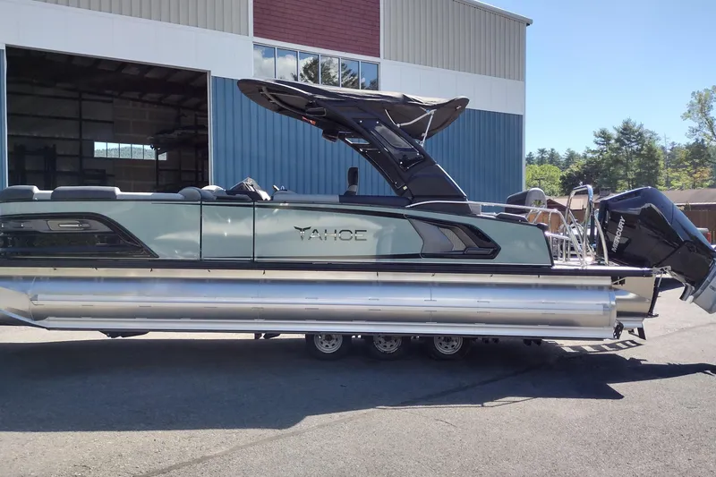 Slide: The Image of 2026 Tahoe Pontoon Grand Tahoe LTD Cruise Rear Bench in a boatyard setting. - 53
