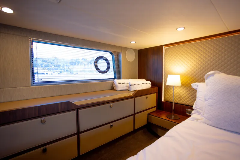 Slide: The Image of Luxurious cabin interior of 2025 Fairline Squadron 50 yacht, featuring elegant design and ambient lighting. - 12