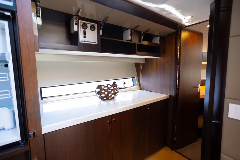 Slide: The Image of Luxurious interior of 2025 Fairline Squadron 50 yacht with modern cabinetry and decor. - 17