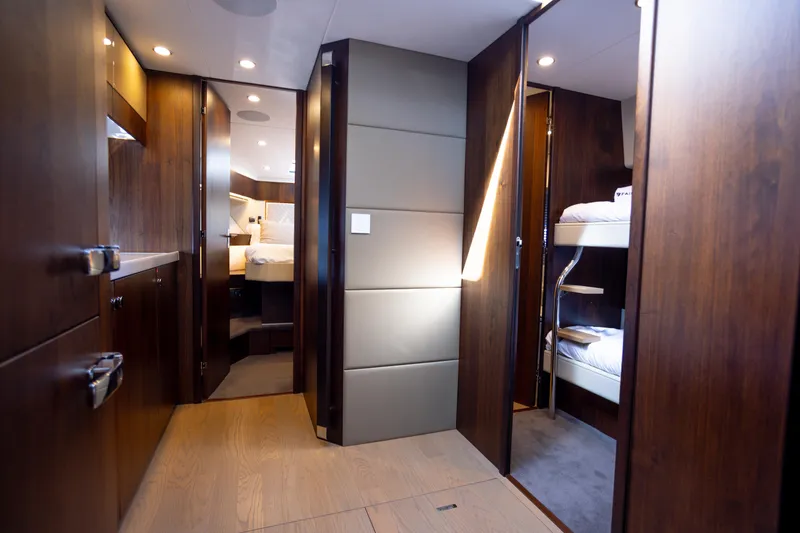 Slide: The Image of Luxurious interior of 2025 Fairline Squadron 50 yacht with modern wood finishes and cozy cabins. - 19