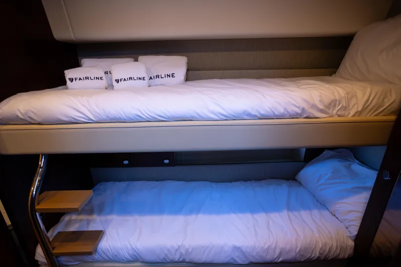 Slide: The Image of Bunk beds in 2025 Fairline Squadron 50 yacht cabin with branded pillows. - 20