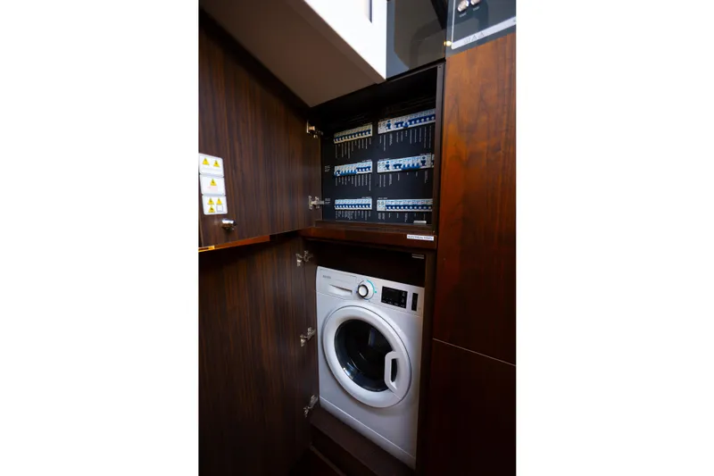 Slide: The Image of Laundry area with washer and control panels on 2025 Fairline Squadron 50 yacht. - 26