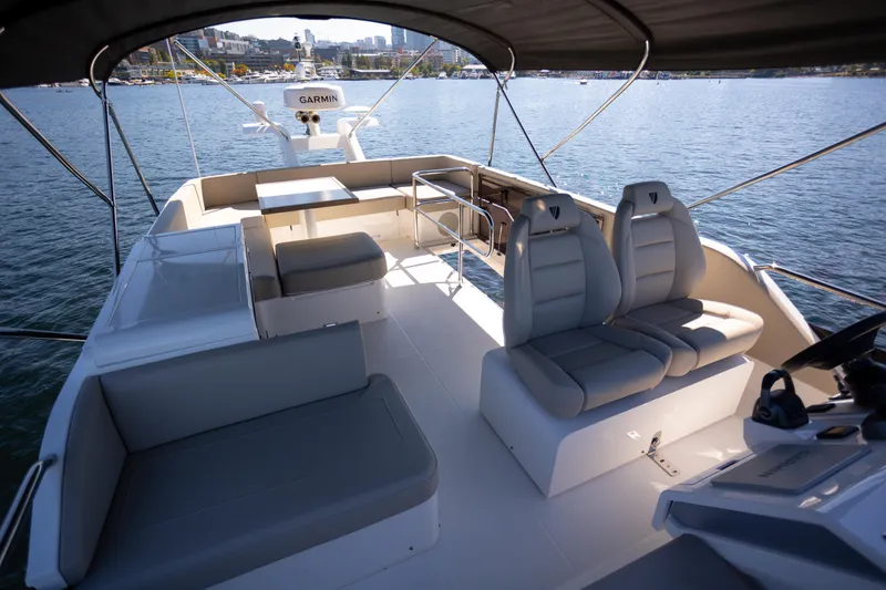 Slide: The Image of Luxurious 2025 Fairline Squadron 50 yacht interior with modern seating and navigation equipment. - 27
