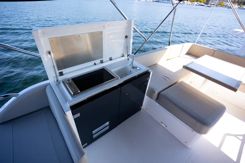Slide: The Image of Luxury outdoor kitchen on 2025 Fairline Squadron 50 yacht, featuring grill and seating area. - 28