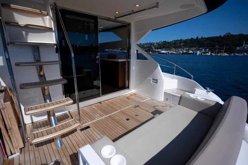Slide: The Image of Luxury Fairline Squadron 50 yacht deck with seating, stairs, and ocean view, 2025 model. - 33