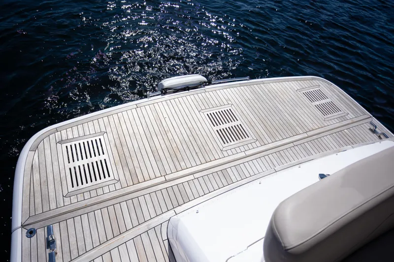 Slide: The Image of Fairline Squadron 50 yacht deck, 2025 model, with teak finish over sparkling water. - 35