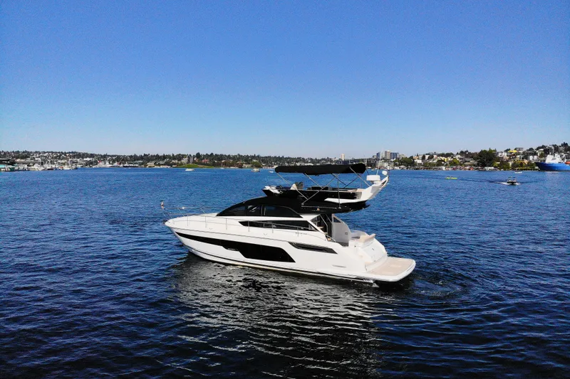 Slide: The Image of 2025 Fairline Squadron 50 yacht cruising on a serene blue lake. - 36