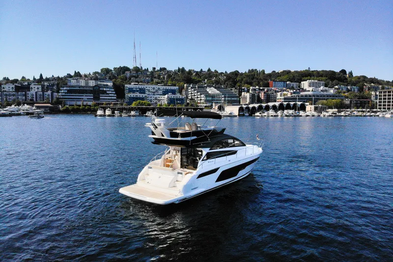 Slide: The Image of 2025 Fairline Squadron 50 yacht cruising near urban waterfront. - 38