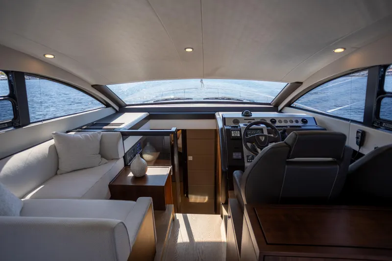 Slide: The Image of Luxurious interior of 2025 Fairline Squadron 50 yacht, featuring modern helm and comfortable seating. - 4