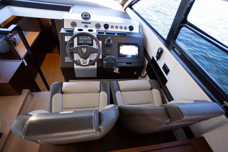 Slide: The Image of Helm of 2025 Fairline Squadron 50 yacht with modern controls and dual seats. - 7