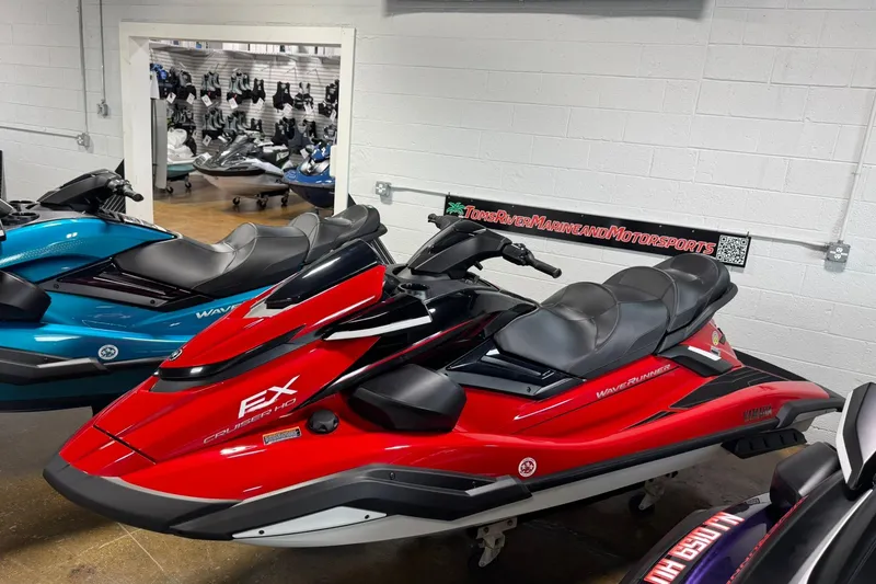 Slide: The Image of 2026 Yamaha WaveRunner FX Cruiser HO in showroom, vibrant red and black design. - 4