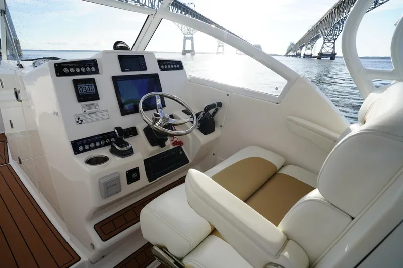 Slide: The Image of 2016 Edgewater 280 CX boat cockpit with modern controls and bridge view. - 11