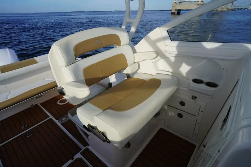 Slide: The Image of Interior of 2016 Edgewater 280 CX boat with tan and white seating. - 13