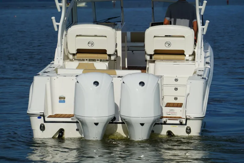 Slide: The Image of 2016 Edgewater 280 CX boat with dual outboard engines on water. - 29