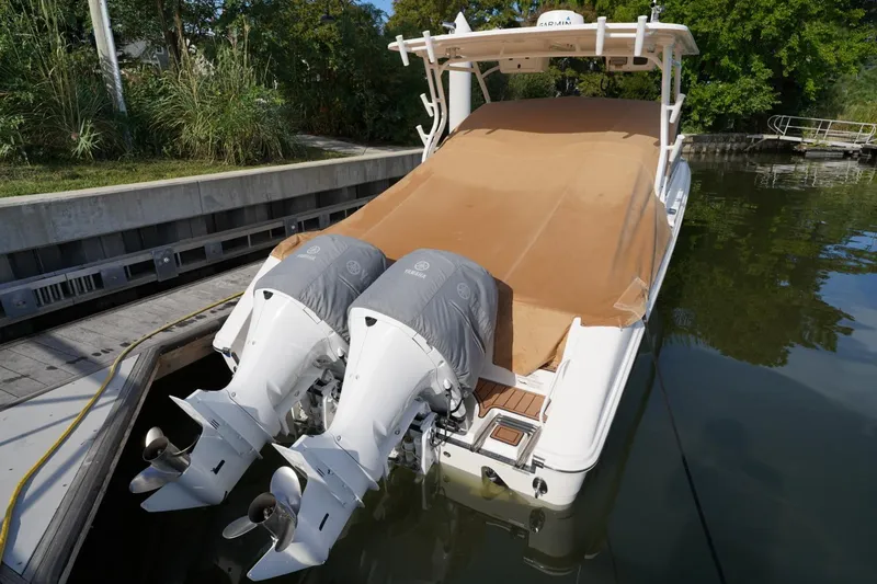 Slide: The Image of 2016 Edgewater 280 CX boat with twin Yamaha outboard engines docked by the water. - 32
