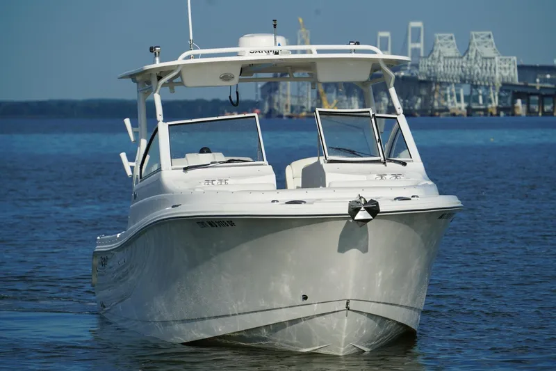 Slide: The Image of 2016 Edgewater 280 CX boat on water with bridge in background. - 4