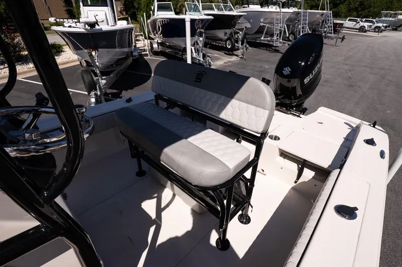 Slide: The Image of 2026 Carolina Skiff 22 Ultra Elite boat interior with seating and Suzuki outboard motor. - 12