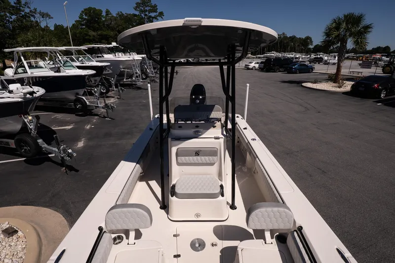 Slide: The Image of 2026 Carolina Skiff 22 Ultra Elite boat displayed in a marina with other vessels. - 14