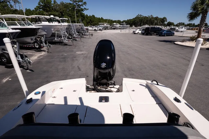 Slide: The Image of 2026 Carolina Skiff 22 Ultra Elite boat with outboard motor in a marina parking lot. - 7