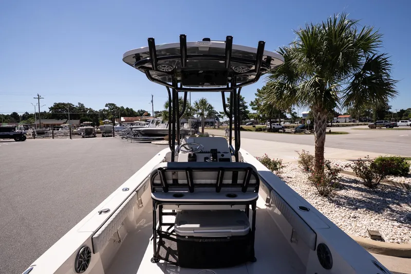 Slide: The Image of 2026 Carolina Skiff 22 Ultra Elite boat parked, featuring spacious deck and T-top, under clear sky. - 9