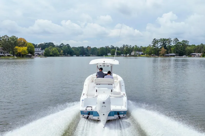 Slide: The Image of 2026 Sea Hunt Ultra 245 SE boat dashboard with steering wheel and control panel. - 10