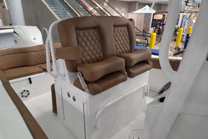 Slide: The Image of 2026 Sea Hunt Ultra 245 SE boat with luxurious brown leather seating. - 15