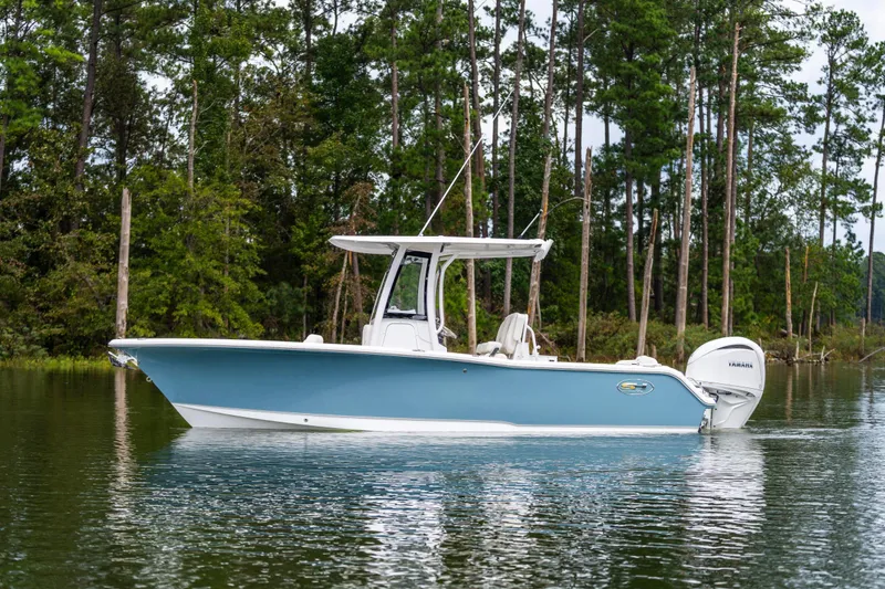 Slide: The Image of 2026 Sea Hunt Ultra 245 SE boat with Yamaha 300 V6 engine at indoor exhibition. - 3