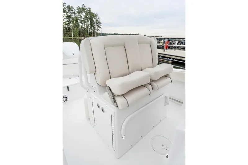 Slide: The Image of 2026 Sea Hunt Ultra 245 SE boat displayed indoors at a showroom. - 5