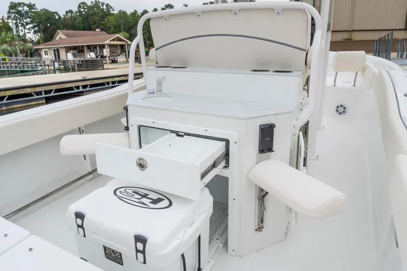 Slide: The Image of 2026 Sea Hunt Ultra 245 SE boat displayed indoors, featuring luxurious seating and modern design. - 7