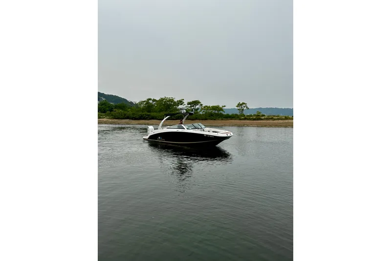 Slide: The Image of 2016 Four Winns Ho270 boat on calm water with scenic background. - 12
