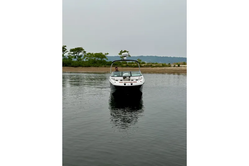 Slide: The Image of 2016 Four Winns Ho270 boat on calm water near shoreline. - 20
